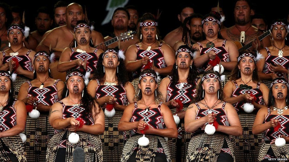 Group of Maori women with traditional facial tattoos posing