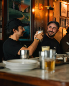 Friends Toasting Drinks in Cozy London Pub